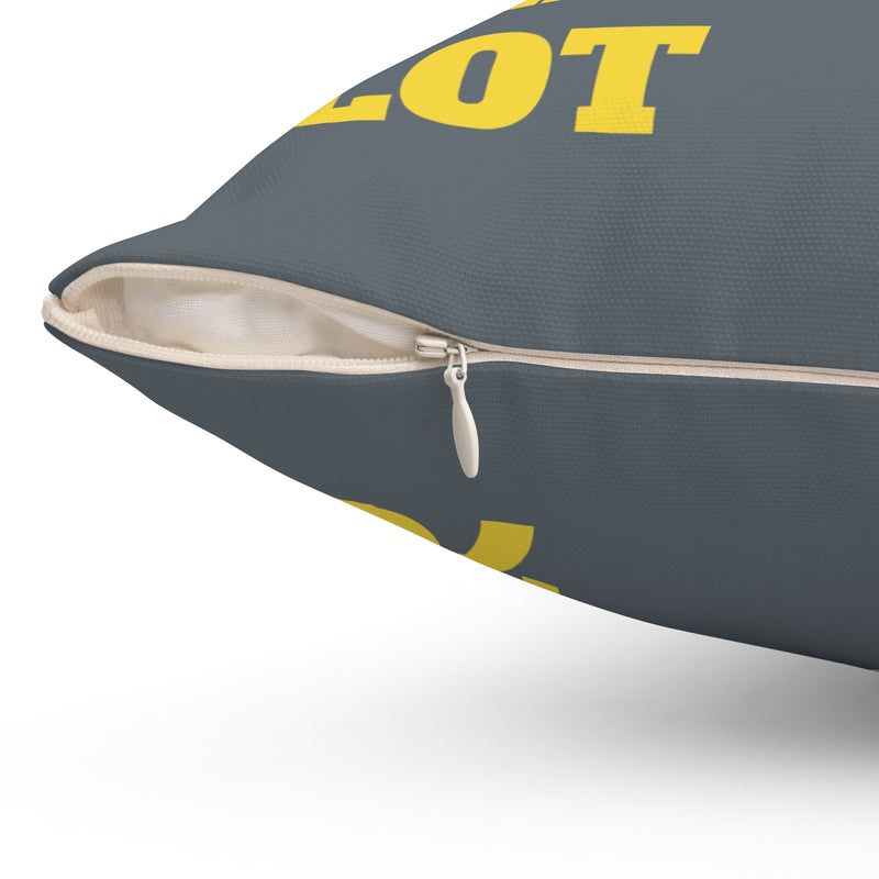 Gray pillow with yellow text on a white background